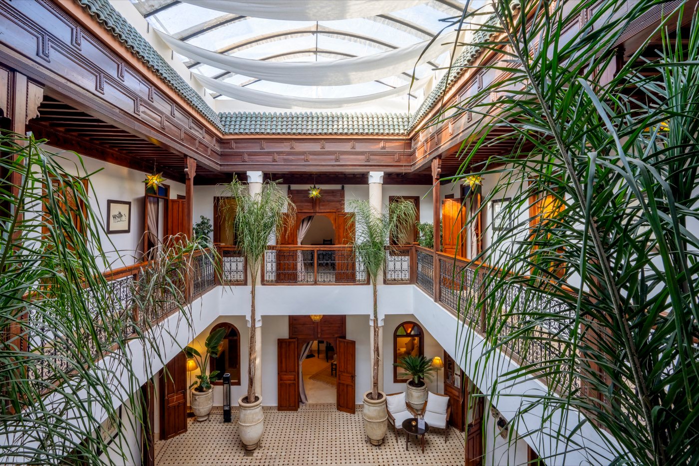The courtyard seen from the upper gallery, looking down past the palms