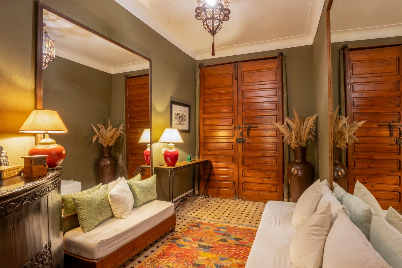 The entrance hall, with its tall cedar doors, long mirror and kilim underfoot